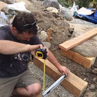 A carpenter installs wood steps